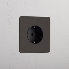 a black light switch on a white wall