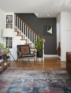 a living room filled with furniture and a stair case