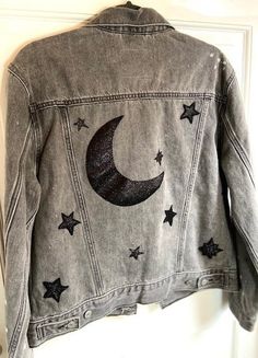 Bring the beauty of the moon and stars right to your closet! Hand sewn moon from black sparkling fabric on the back of this jacket hangs like it does in the night sky. Same fabric, hand sewn stars (13 to be exact; a lucky number) placed around jacket. Glitter lightly spread all over jacket to make any gloomy day glow or make a sunny day even brighter! Moon Clothes, Space Jacket, Emo Hoodie, Moon Jacket, Space Clothing, Sparkling Fabric, Jean Jacket Diy, Star Jacket, Over Jacket