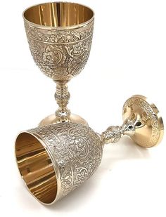 an ornately decorated silver goblet on a white background