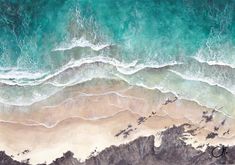 an aerial view of the ocean and beach with waves crashing on it's shore