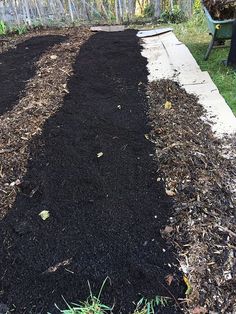 the garden is ready to be planted and put into the ground by the fenced in area