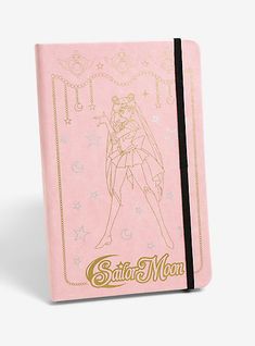 the sailor moon notebook is pink with gold lettering