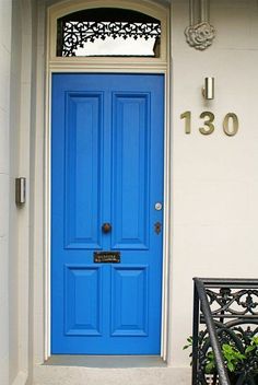 a blue front door on a white house