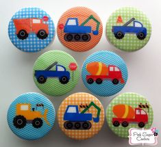 six buttons with different colored trucks on them