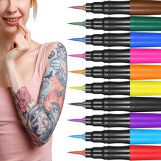 a woman with many different colored markers on her arm and arms, next to an assortment of pens