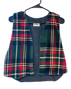 One of one handmade reversible vest  Upcycled from vintage fabric  Flannel side is super soft to the touch  Can be worn on either side  Measurements:  Across chest: 15in Across waist: 19in  Length (longest part): 19in  *all items are handmade. Please hand wash and hang to dry for best results. Fitted Plaid Vest For Winter, Fitted Multicolor Vest For Winter, Multicolor Fitted Winter Vest, Winter Multicolor Fitted Vest, Fitted Plaid Cotton Vest, Flannel Vest, One Of One, Reversible Vest, Faux Fur Vests