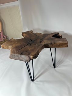 a wooden table with hairpin legs and a wood slab on it's side