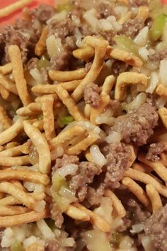 a close up of a plate of food with noodles and ground beef in the middle