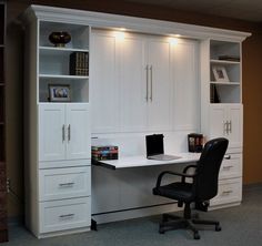 an office with white cabinets and a black chair in front of the desk is illuminated by recessed lighting