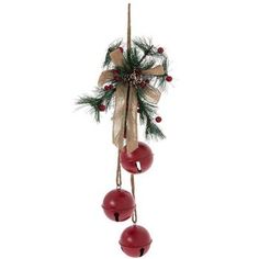 a christmas decoration hanging from a pole with bells and pine cones on it's side