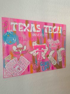 there is a pink sign on the wall that says texas tech and it's surrounded by other stickers