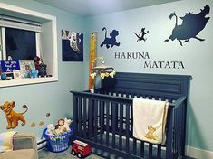 a baby's nursery room with blue walls and winnie the pooh wall decals