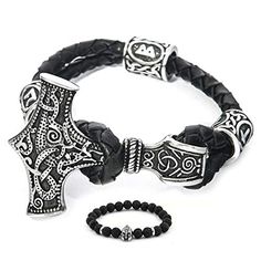 a black leather bracelet with an iron cross on it and a silver beaded charm