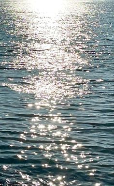 the sun shines brightly on the water as it reflects off the surface of the ocean