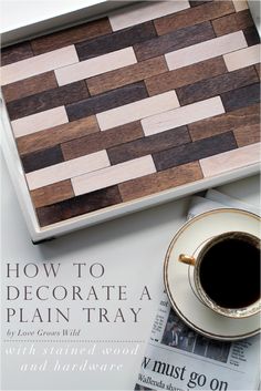 a wooden tray sitting on top of a table next to a cup of coffee