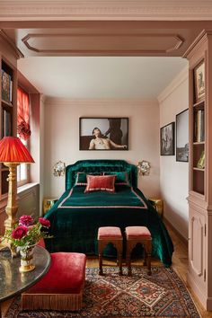 a green velvet bed in a bedroom with pink accents