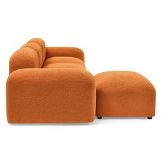 an orange couch and footstool sitting next to each other on a white background