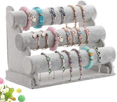 a display rack with rings and bracelets on it, next to candy candies