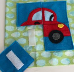 a blue and green blanket with a red car on it