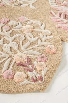 an area rug with flowers and leaves on the floor in front of a white background