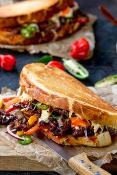 a sandwich is cut in half on a cutting board