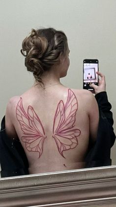 a woman is taking a selfie with her cell phone in front of the mirror