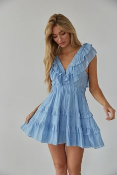 Embrace your femininity in the Xena Flutter Sleeve Babydoll Mini Dress! This mini dress features flutter sleeves, a V-neckline, tiered ruffle skirt, and a triple clasp bust detail. Available in white and blue. Pair with some heels to complete the look! Details 75% Rayon, 25% Nylon Lining: 100% Polyester Elastic waistband Elastic band sleeves Hand wash cold Spring Break Dress, Flowy Dress Short, Rush Outfits, Beachy Dresses, Sorority Rush, Babydoll Mini Dress, Tiered Mini Dress, Preppy Dresses, Tiered Ruffle Skirt