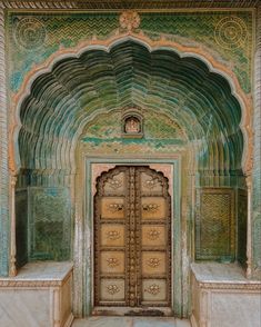 an ornate doorway with two benches in front of it