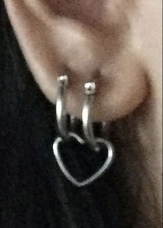 an earring with a heart hanging from it