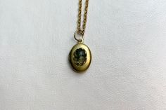 "This sweet, small, OVAL antique brass locket has a faceted Moss Agate cabochon set on the front.  The cabochon sits in a brass lace edged setting. It hangs on a 16\" gold-plated stainless-steel chain necklace.  The locket is approximately 11x16mm.  The cabochon is 5x7mm.  Arrives in an eco-friendly jewelry box, ready for gifting. MORE lockets in my shop! FREE SHIPPING! THANK YOU FOR VISITING MY SHOP!" Stainless Steel Chain Necklace, Agate Cabochon, Eco Friendly Jewelry, Lace Edging, Moss Agate, Steel Chain, Stainless Steel Chain, Locket, Antique Brass