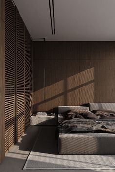 a bed sitting in the middle of a bedroom next to a wooden wall and floor