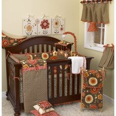 a baby crib bedding set with sunflowers on it and matching curtains