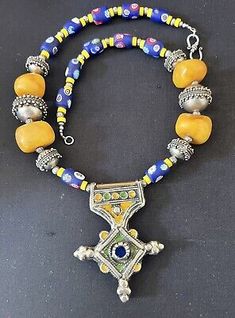 Morrocan Boghdad enameled Berber cross, yellow copal & Blue Millefiori Necklace  | eBay Yellow Pendant Jewelry For Festivals, Artisan Yellow Necklaces For Festivals, Yellow Pendant Necklace For Festivals, Artisan Yellow Jewelry For Festival, Yellow Polished Beads Jewelry For Festival, Everyday Pendant, African Necklace, Handmade Jewelry Necklace, Bib Necklaces