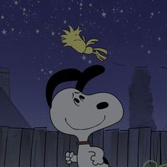 a cartoon dog is standing in front of a fence and looking up at the sky