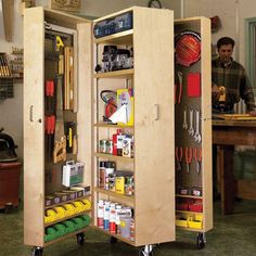 an open cabinet with tools on wheels in a room filled with other items and people