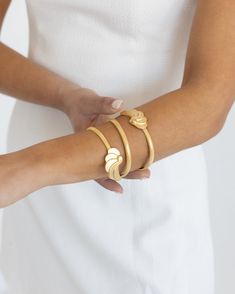 Wrap your wrist with one of the most coveted styles from the late 60s and 70s. Inspired by fabulous women and their best accessories, our Athens Wrap Bracelet is all you need to dress up your every day. Unique in shape and lightweight to wear, it’s the perfect piece to jazz up your jewelry box. Looking closely, you’ll notice that the textured look of the band comes from an intricate design of small diamond-shaped indentations. Made complete with our Athens pendant at each end, this bracelet is s Modern Adjustable Evening Bracelets, Chic Evening Bracelet Jewelry, Chic Evening Bracelets, Chic Evening Jewelry Bracelet, Adjustable Jubilee Bracelet For Evening, Chic Evening Bangle Jewelry, Chic Jubilee Bracelet Bangle For Party, Chic Cuff Bracelets For Wedding, Chic Adjustable Bangle For Formal Occasions