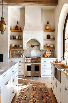 Elegant Spanish style kitchen with white cabinetry, wooden accents, and intricate tile backsplash. Spanish White Kitchen, Spanish Tile Interior Design, Spanish Inspired Interior, Desert Inspired Kitchen, Spanish Style Tile Kitchen, Small Tiles Kitchen, Spanish Tile Kitchen Backsplash, Spanish Style Backsplash, Mediterranean Tiles Kitchen