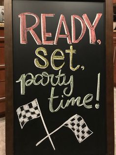 a chalkboard sign with the words ready set party time written in cursive writing