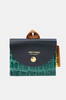 Envoy easily holds upwards of seven cards in a luxe glazed calf leather. A nylon webbing folded loop accent is a nod to the season's journey of exploration. DESIGN- A mini wallet in croc-embossed leather for credit cards and bills.- Flap closure with gold snap- Width: 4.25", Height: 3 1/2", Depth: 1.2"FABRIC & CARE- 100% calf leather- Ethically made in the U.S.A.SUSTAINABILITY- This product was created using a custom pattern to create the amount of material waste possible.- Designed and manu Green Leather Business Wallets, Functional Leather Trifold Wallet, Green Travel Wallet With Coin Pocket, Functional Leather Trifold Wallet For Daily Use, Modern Green Travel Wallets, Modern Green Travel Wallet, Functional Leather Card Holder For Daily Use, Functional Leather Trifold Wallet With Card Slots, Green Leather Card Holder With Rfid Blocking