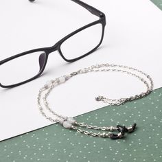 Modern glasses chain - White jade gemstone and grey bead eyewear chain White jade gemstones with grey faceted glass beads and Tibetan silver beads feature in a silver tone oval link chain. Perfect for everyday wear and keeping your glasses or sunglasses handy. Finished with spectacle ends to hold your glasses. Approximately 26 inches long. Handmade in the UK, in stock and ready to ship. More glasses chains available in my store here - https://www.etsy.com/shop/inspira?section_id=20362036 California Lilac, Eyeglasses Chain, Eyewear Chain, Glasses Chains, Sunglasses Strap, Jade Gemstone, Grey Beads, Eyeglass Chain, White Jade