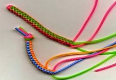 several different colored bracelets on a white surface