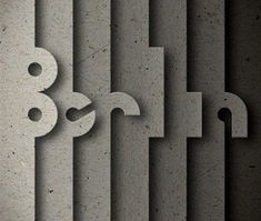 the letters are made out of concrete blocks and have been cut into smaller shapes with scissors