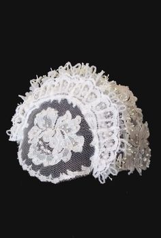 a white lace doily on a black background