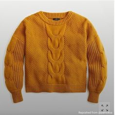 an orange sweater is hanging on the wall