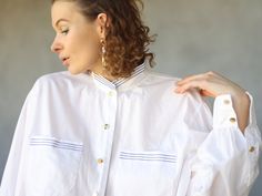 Vintage white cotton striped collar button up long sleeve blouse shirt. Long sleeves, gold tone buttons down the front, chest pockets, no lining. Material is cotton. Tag: BC Size 46 Will fit up to size XL Measured laying flat (double for circumference): 25.5'' / 65 cm long 24.5'' / 62 cm armpit to armpit 24'' / 61 cm waist 19'' / 48 cm shoulders 24'' / 61 cm sleeve length Great vintage condition. White Button-up Shirt With Striped Cuffs, White Shirt With Striped Collar For Work, Spring White Shirt With Striped Cuffs, White Shirt With Striped Cuffs For Spring, White Long Sleeve Blouse With Striped Collar, Daywear Long Sleeve Shirt With Striped Cuffs, Long Sleeve Shirt With Striped Cuffs For Daywear, White Striped Collar Button-up Blouse, White Button-up Blouse With Striped Collar