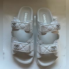 Bnwt Chanel 24p G45507b15805 White Backless Cc Logo Slide Dad Sandals, Size 38.5. Serial Number In Last Two Images. Brand New. 100% Authentic. Includes Box, Dust Bags, Cards. The Most In Demand Shoe On The Market From Chanel Spring Collection. Beautiful White Quilted Lambskin Leather With Cc Logo’s Made In Italy. All Sales Are Final. Item Will Be Shipped Insured Requiring Adult Signature. Chanel Slides Sandals, Chanel White Sandals, White Chanel Sandals, Luxury Platform Slip-on Sandals, Luxury Leather Platform Slides, Luxury Slip-on Platform Sandals, Luxury White Open Heel Sandals, Luxury Slides With Platform And Round Toe, Luxury Slides With Removable Insole