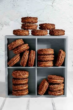 cookies stacked on top of each other in a gray box with white walls behind them