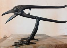 a sculpture of a bird with spikes on its legs