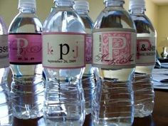 six bottled water bottles lined up on a table